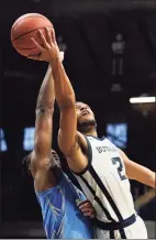  ?? Darron Cummings / Associated Press ?? Butler’s Aaron Thompson puts up a shot against Creighton’s Denzel Mahoney during the second half on Saturday in Indianapol­is. Butler won 70-66 in overtime.