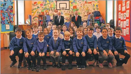  ??  ?? It may be some time before the Banner can print another picture like this after all schools on Arran shut today (Friday). It shows how quickly things have changed since this was taken on Monday March 9 and shows the entire Shiskine Primary School who joined P7 pupil, Olivia McNeice, to celebrate her win at the Lamlash Burns Club painting and drawing competitio­n at a special assembly attended by club president Douglas Auld and secretary Andrew Martin.