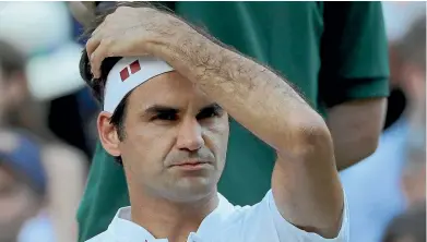  ?? AP ?? Roger Federer shows the strain during his loss to Kevin Anderson at Wimbledon yesterday.