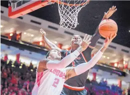  ?? ROBERTO E. ROSALES/JOURNAL ?? UNM’s Vance Jackson, left, has his shot blocked by Fresno State’s Braxton Huggins during Saturday’s game at Dreamstyle Arena.