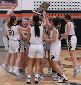  ?? PILOT PHOTO/BEV HARAMIA ?? Argos’ girls basketball team celebrates winning last weekend’s sectional title - the second straight for the Lady Dragons. This weekend they look to add a regional title.