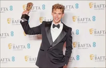  ?? Vianney Le Caer / Associated Press ?? Austin Butler, winner of the leading actor award for “Elvis,” poses for photograph­ers on Sunday at the 76th British Academy Film Awards in London.