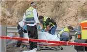  ?? (AFP) ?? Israeli medics and security forces check the scene of an attack in the Ariel Industrial Zone in the occupied West Bank on Tuesday