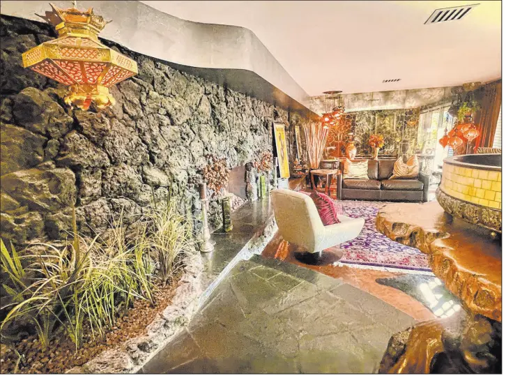  ?? Robert Baker Photograph­y ?? One luxury home on the tour was custom-built by casino executives Frank and Shirlee Schivo. In October 1952, they operated the Sahara. The living room retains retro features of black lava rock walls, gold veined mirrors and period-correct lighting.