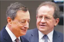  ?? AP PHOTO ?? President of the European Central Bank Mario Draghi, left, and vice-president Vitor Constancio go to a news conference in Frankfurt, Germany.