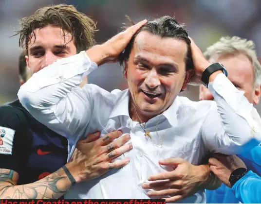  ?? AP, Reuters, Rex Features ?? Croatia head coach Zlatko Dalic celebrates with players after his team advanced to the final by defeating England in the semifinals of World Cup in the Luzhniki Stadium in Moscow on Wednesday.