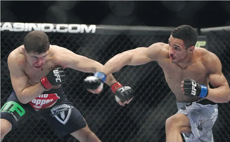  ?? — THE ASSOCIATED PRESS FILES ?? Kevin Lee, right, pictured against Al Iaquinta in Newark, N.J., in 2014, enters Sunday’s UFC Fight Night main event on a four-fight winning streak.