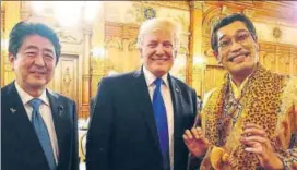  ?? REUTERS ?? US President Donald Trump and Japanese Prime Minister Shinzo Abe pose with Jpop star Pikotaro, famous for the viral ApplePen song, during an official dinner at Akasaka Palace in Tokyo.