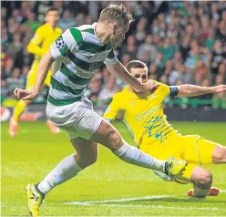  ?? Pictures: SNS/PA. ?? Top: Tom Rogic starts the Celtic rout, with his shot turned into his own net by Astana’s Aleksandr Mokin; above: James Forrest drives home the fourth goal.