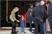  ?? SUSAN WALSH - THE ASSOCIATED PRESS ?? First Lady Jill Biden, left, walks with her grandson Beau Biden, as President Joe Biden, second from right, talks with firefighte­rs during a visit to the Nantucket Fire Department on Thanksgivi­ng Day in Nantucket, Mass., Thursday.