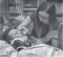  ??  ?? Fred Stonehouse’s sister Fay cleans his face at Pittsburgh’s Allegheny General Hospital. He still has post-concussion symptoms.