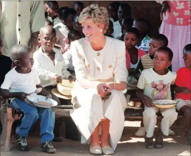  ?? PICTURE: JIM MCLAGAN ?? THE PEOPLE’S PRINCESS: Princess Diana with children at a Red Cross feeding scheme in Zimbabwe in July 1993.