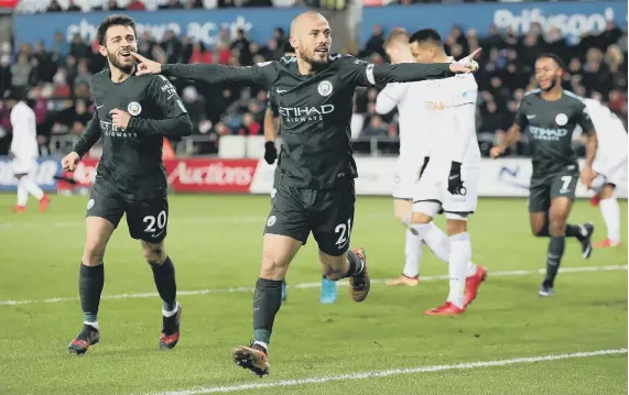  ??  ?? Manchester City’s David Silva (centre) celebrates scoring his side’s third goal of the game.