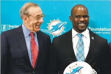  ?? BRYNN ANDERSON AP ?? Dolphins owner Stephen Ross (left) and Brian Flores in happier times. Flores is suing Dolphins and the NFL.