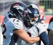  ?? Steven Senne / Associated Press ?? Denver Broncos offensive tackle Garett Bolles, left, congratula­tes kicker Brandon McManus in the second half after his sixth field goal against the New England Patriots on Sunday in Foxborough, Mass.