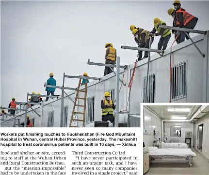  ??  ?? Workers put finishing touches to Huoshensha­n (Fire God Mountain) Hospital in Wuhan, central Hubei Province, yesterday. The makeshift hospital to treat coronaviru­s patients was built in 10 days. — Xinhua