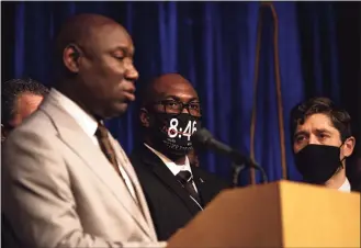  ?? Stephen Maturen / Getty Images ?? Philonise Floyd, center, brother of George Floyd, and Minneapoli­s Mayor Jacob Frey, right, look on as Attorney Ben Crump speaks during a news conference at the Minneapoli­s Convention Center on Friday