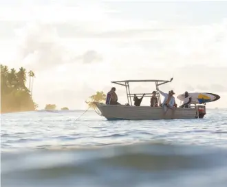  ??  ?? On for the ride ... tenders are taken out to surf breaks each day from the PNG Explorer.