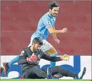  ?? AFP ?? Man City's Ilkay Gundogan celebrates scoring his team's second goal as Liverpool goalkeeper Alisson (ftont) reacts on Sunday.