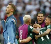  ?? EDUARDO VERDUGO — ASSOCIATED PRESS ?? Germany goalkeeper Manuel Neuer walks past as Mexico players celebrate after defeating Germany, 1-0, in their Group F match at the World Cup.