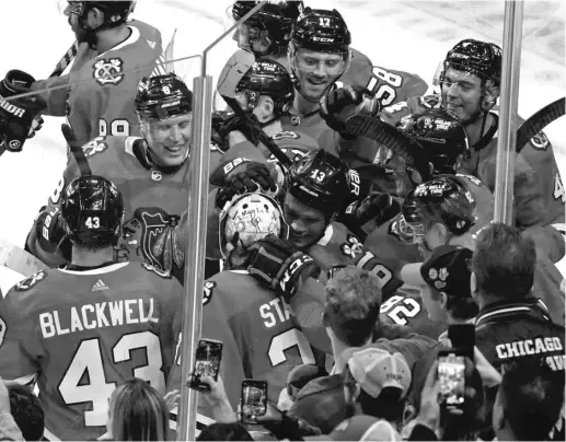  ?? DAVID BANKS/AP ?? Max Domi (13) and the Blackhawks, celebratin­g his winning goal Friday, have bought into coach Luke Richardson’s systems and message.