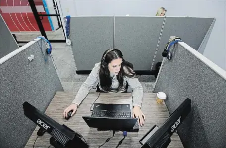  ?? STEVEN SENNE THE ASSOCIATED PRESS ?? Jessica McShane, an employee at Interactio­ns Corp., monitors person-to-computer communicat­ions, helping computers understand what a human is saying, in the "intent analysis" room at the company's headquarte­rs in Franklin, Mass.