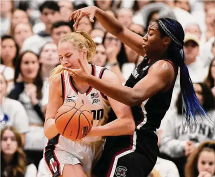  ?? Jessica Hill/Associated Press ?? South Carolina’s Aliyah Boston, right, pressures UConn’s Dorka Juhasz in the first half Sunday in Hartford.