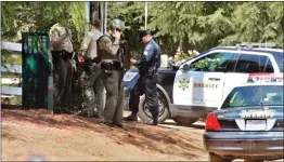  ?? Dan Watson/The Signal ?? Los Angeles County sheriff’s deputies and California Highway Patrol officers gather in front of a home on Crown Valley Road after a report of an armed, barricaded suspect in Acton on Saturday.