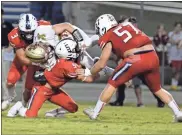  ?? Michelle Petteys, Heritage Snapshots ?? Paxton McCrary (3), Ryan Heet (5) and Trey Weldon (57) upend Christian Heritage running back Eli Thomason during Friday’s contest. The Generals got a late TD from McCrary and used a final fourth-down stop to seal a 25-24 victory.
