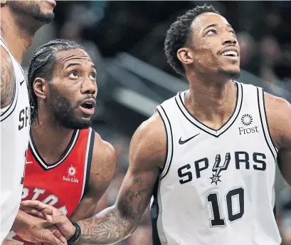  ?? ERIC GAY THE ASSOCIATED PRESS ?? Raptors forward Kawhi Leonard and San Antonio Spurs guard DeMar DeRozan jockey for a rebound on Thursday night.