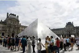  ?? ?? In this file photo taken on July 19, 2019 Tourists queue outside the Pyramid prior entering the Louvre museum in Paris on July 19, 2019. (AFP)