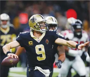  ?? Associated Press ?? Back to pass: This Dec. 24, 2017 file photo shows New Orleans Saints quarterbac­k Drew Brees (9) passing in the second half of a game against the Atlanta Falcons in New Orleans. Brees is on the verge of reclaiming an NFL record this week, just weeks...