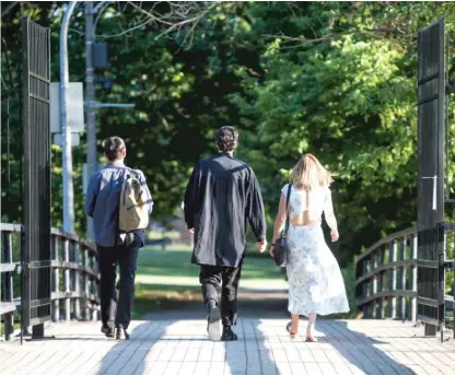  ?? SUN-TIMES FILES ?? People walk past the gate at the southern entrance of the Wooded Isle in Jackson Park.