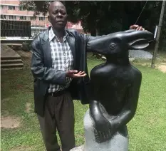  ??  ?? Legend Sylvester Mubayi stands next to one of his iconic pieces at the National Art Gallery last week