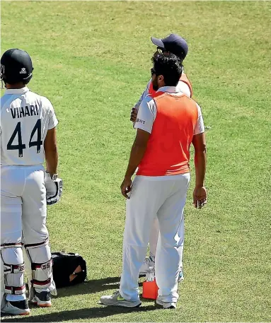  ??  ?? Ravichandr­an Ashwin receives attention after being struck by a short ball during day five of the third test match between India and Australia in Sydney.
INSET: India’s Washington Sundar avoids a bouncer from Australia’s Mitchell Starc during play on day three of the fourth test.