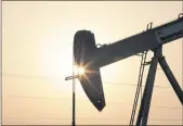  ?? HASAN JAMALI — THE ASSOCIATED PRESS FILE ?? An oil pump works at sunset in the desert oil fields of Sakhir, Bahrain.