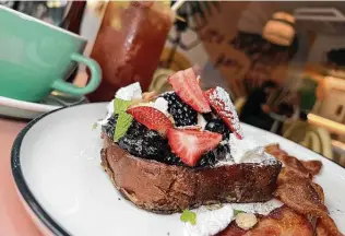  ?? ?? The Milk Bread French Toast is piled high with lemon mascarpone, berry compote, candied nuts and meringue.