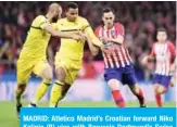  ??  ?? MADRID: Atletico Madrid’s Croatian forward Niko Kalinic (R) vies with Borussia Dortmund’s Swiss defender Manuel Akanji during the UEFA Champions League group A football match between Club Atletico de Madrid and Borussia Dortmund at the Wanda Metropolit­an stadium in Madrid. — AFP