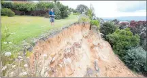  ??  ?? Omokoroa ¯ resident John Roper and the section of the slip that threatened his Ruamoana Place home, taken December 14, 2017.