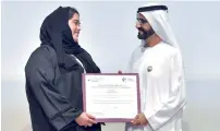  ??  ?? A representa­tive of Amal Education Limited receives her certificat­e from Sheikh Mohammed for their support to Dubai Cares.