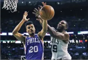  ?? THE ASSOCIATED PRESS FILE ?? Sixers guard Timothe Luwawu-Cabarrot, left, battles the Celtics’ Jae Crowder for a rebound in a game last February in Boston.