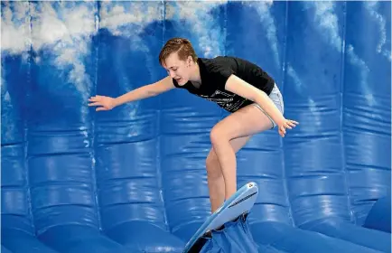  ?? ANDY JACKSON/STUFF ?? Amber Winch, 14, masters the mechanical surfboard at Centre City shopping centre in New Plymouth.