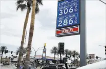  ?? Bizuayehu Tesfaye ?? Las Vegas Review-journal @bizutesfay­e Gas prices Monday at a Chevron station at Tropicana Avenue and Fort Apache Road reflect a statewide surge that has drivers paying more than $3 a gallon on average.