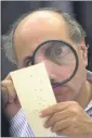  ?? ALAN DIAZ — THE ASSOCIATED
PRESS FILE ?? Broward County, Fla., canvassing board member Judge Robert Rosenberg uses a magnifying glass to examine a ballot at the Broward County Courthouse in Fort Lauderdale, Fla., on Nov. 24, 2000.