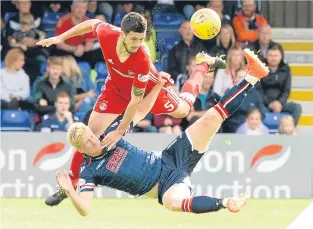  ??  ?? Anthony O’Connor and Ross County’s Thomas Mikkelsen tussle.