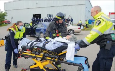  ?? WAYNE EMDE/Special to The Daily Courier ?? Cadets attending the Jean Minguy Memorial Youth Academy in Vernon witnessed a mock accident demonstrat­ion on Thursday morning that showcased the co-operation that happens when first responders attend an accident scene. RCMP members, firefighte­rs and paramedics each played specific roles in securing the scene, tending to the victims and transporti­ng them to hospital. The cadets were required to take notes of everything they witnessed. Later, they were given close-up looks at the ambulance, fire truck and other emergency vehicles and got a chance to ask questions of the first responders.