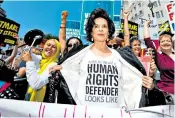  ??  ?? From left, antitrump protesters in Regent Street; Bianca Jagger makes her point with her T-shirt; marchers in Whitehall, while, below, a dogged member of the Women Against Trump march