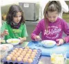  ?? PHOTO: REBECCA NADGE ?? Cook off . . . Billie Nixon (9) and Belinda Hope (8), both of Haast, race against the clock in the whitebait pattie cooking competitio­n at the Haast Whitebait Festival.