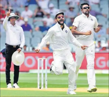  ?? REUTERS ?? ■ Virat Kohli and Ravichandr­an Ashwin celebrate the dismissal of Marcus Harris (not in the picture) during the second day of the first Test between Australia and India at the Adelaide Oval on Friday. India are still 59 runs ahead.