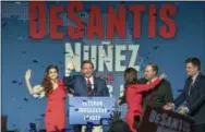  ?? CHRIS URSO/TAMPA BAY TIMES VIA AP ?? Republican Florida Governor-elect Ron DeSantis, center, waves to supporters with his wife, Casey, left, and Republican Lt. Governor-elect Jeanette Nunez, third right, after thanking the crowd Tuesday in Orlando, Fla.